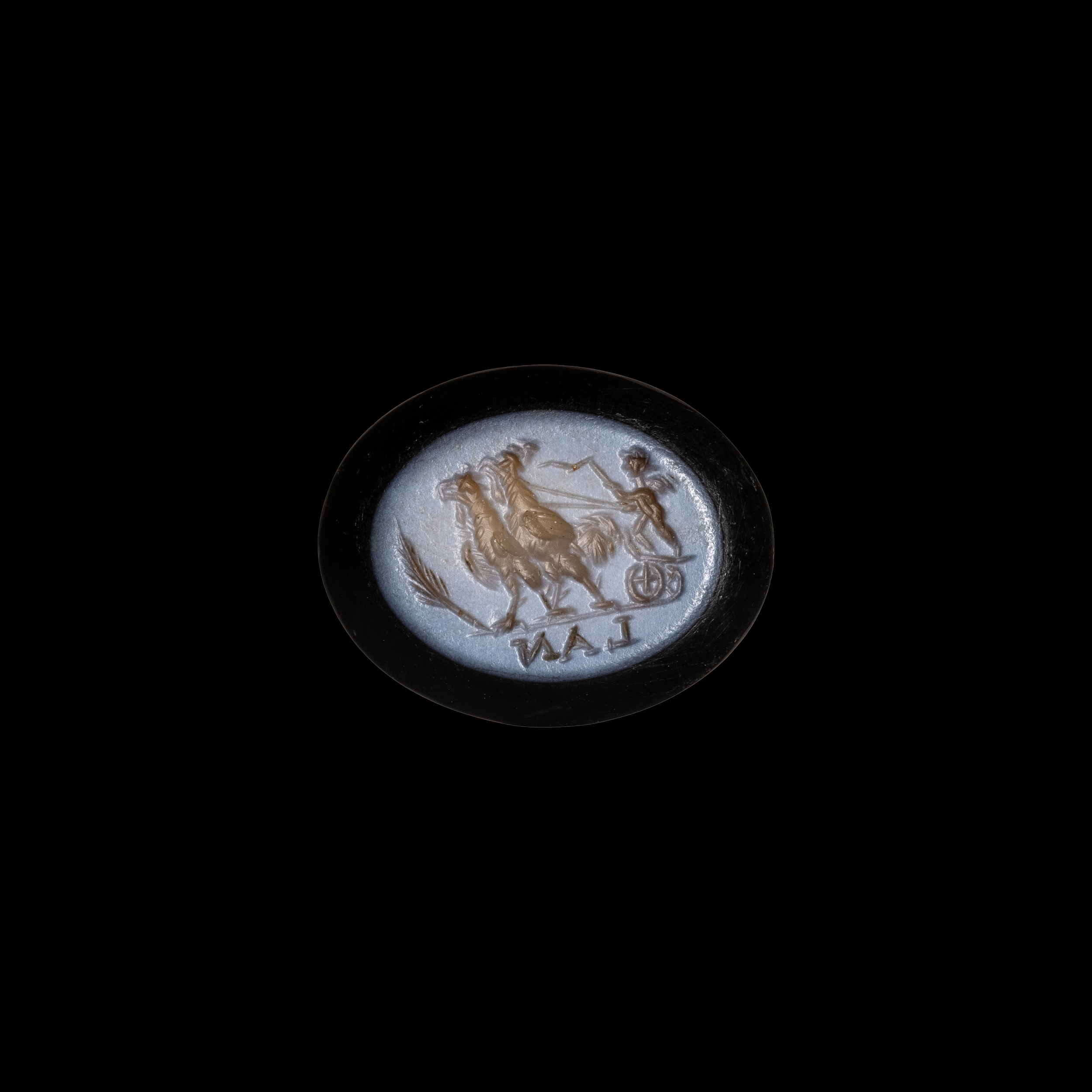 A Roman nicolo intaglio. Eros riding a chariot pulled by two roosters.